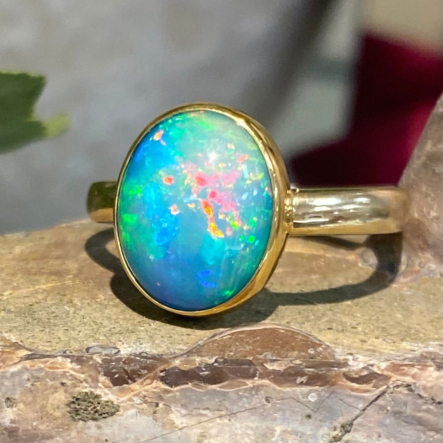 Photo of Ethiopian Opal Ring in a decorative scene, designed by , available at Plumb Gold & Plumb Silver