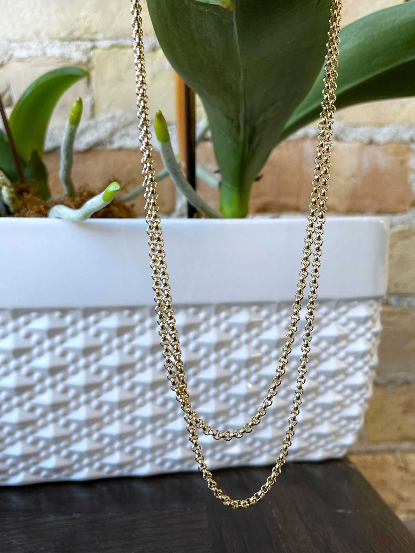 Photo of Fancy Curb Link Chain in a decorative scene, designed by , available at Plumb Gold & Plumb Silver