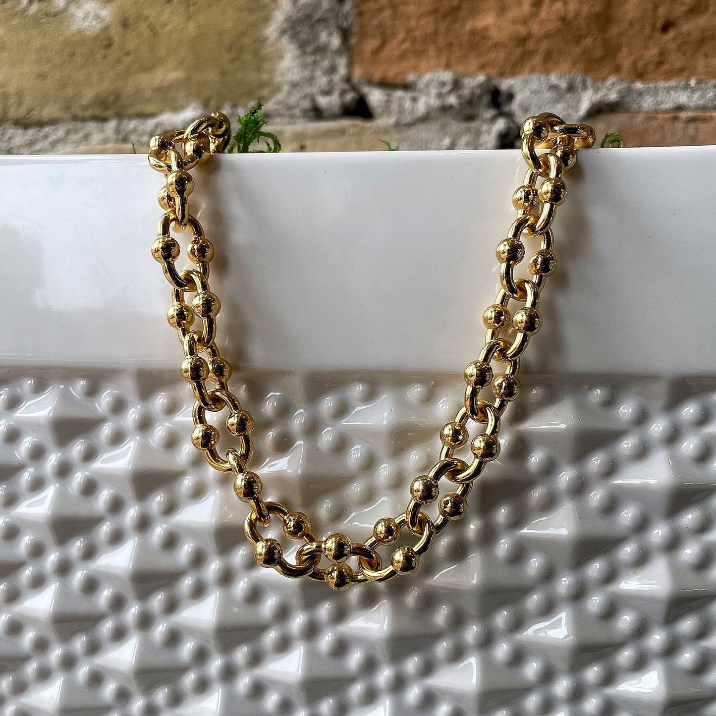 Photo of Fancy Link Chain in a decorative scene, designed by , available at Plumb Gold & Plumb Silver