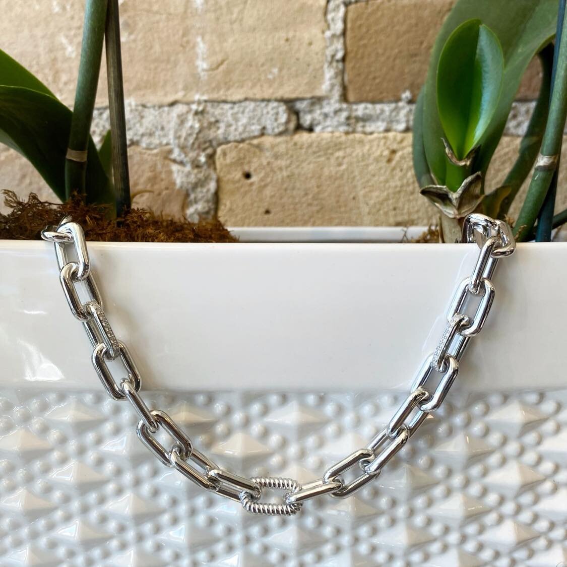 Photo of Fancy Square Link Necklace in a decorative scene, designed by , available at Plumb Gold & Plumb Silver