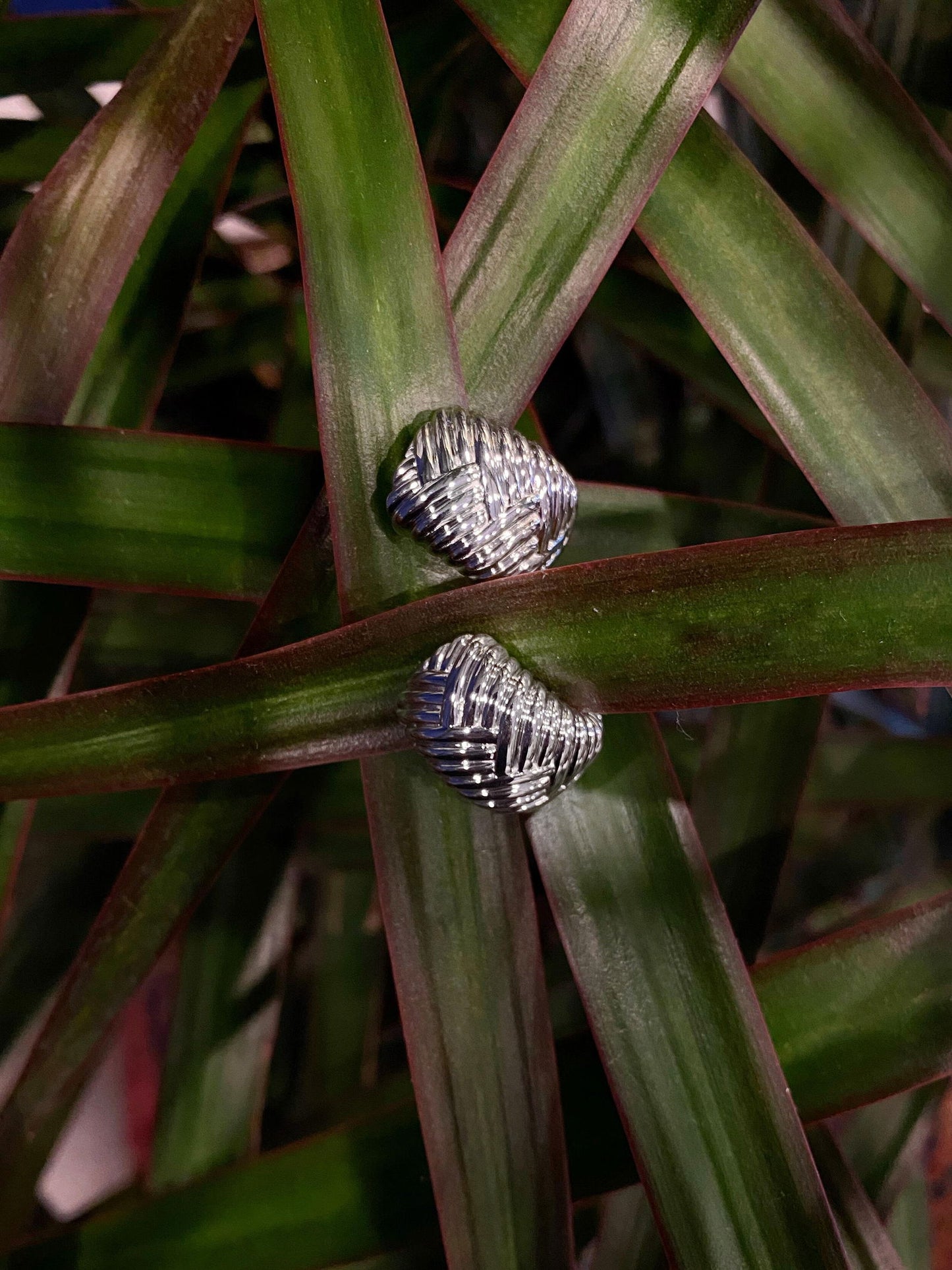 Photo of Fishtail Huggies in a decorative scene, designed by , available at Plumb Gold & Plumb Silver