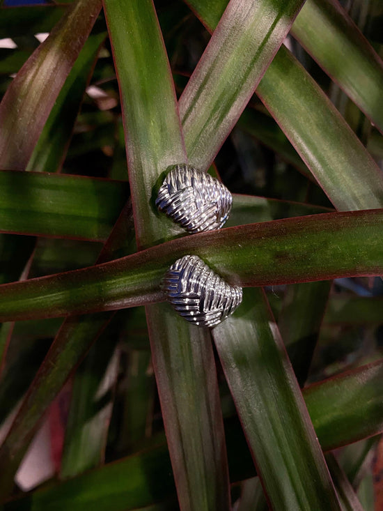Photo of Fishtail Huggies in a decorative scene, designed by , available at Plumb Gold & Plumb Silver