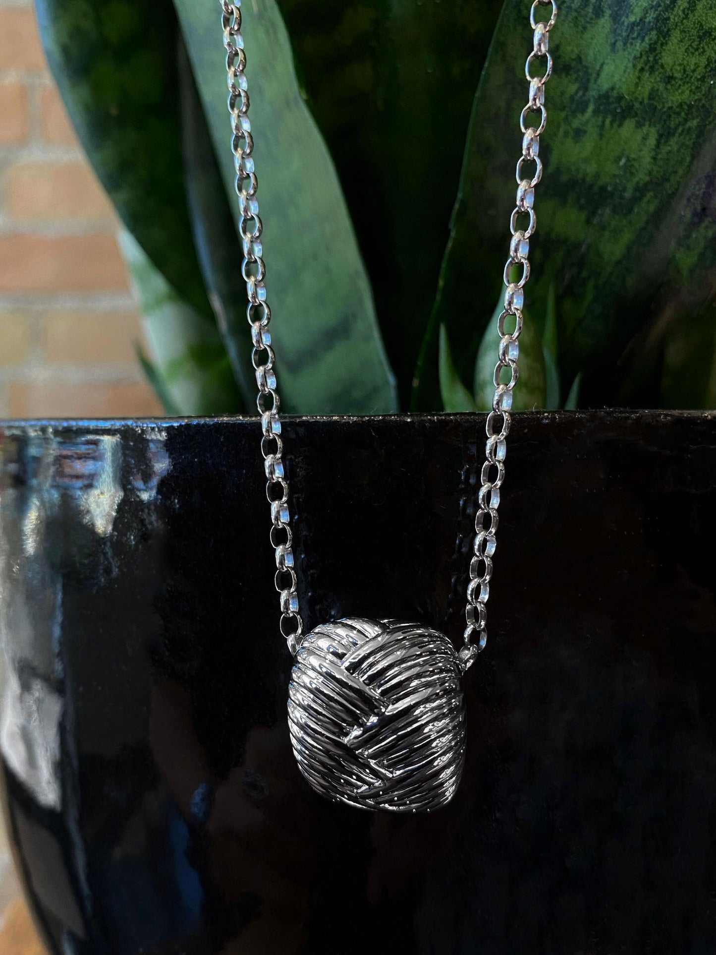 Photo of Fishtail Pendant in a decorative scene, designed by , available at Plumb Gold & Plumb Silver