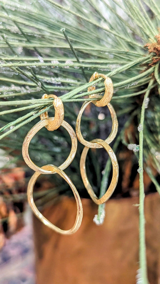 Photo of "Florence" Dangle Earring in a decorative scene, designed by , available at Plumb Gold & Plumb Silver
