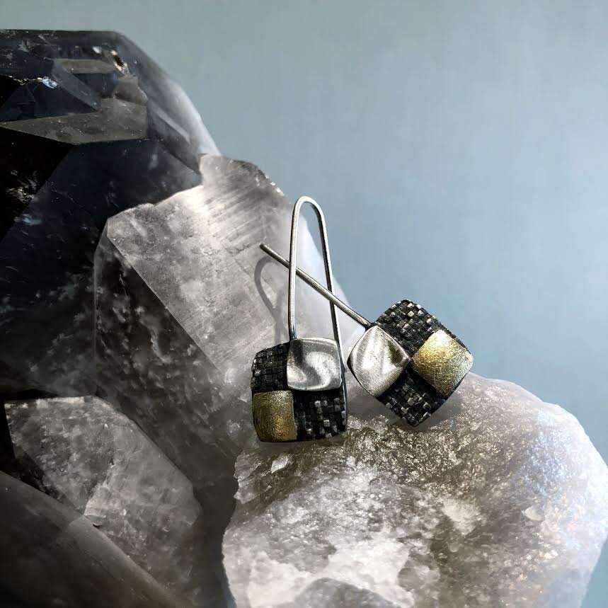Photo of Four Square Earrings in a decorative scene, designed by , available at Plumb Gold & Plumb Silver