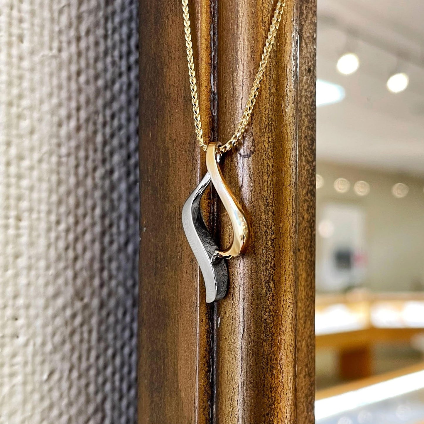 Photo of Freeform Pendant in a decorative scene, designed by , available at Plumb Gold & Plumb Silver