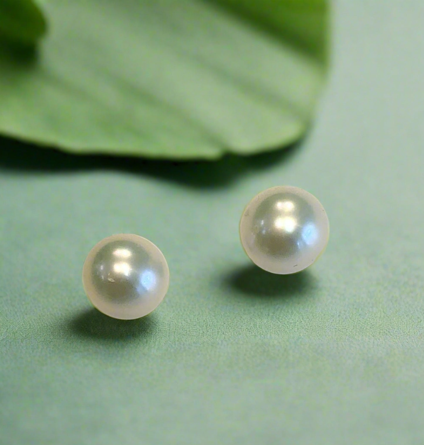 Photo of Freshwater Pearl Stud earrings 5-6mm in a decorative scene, designed by , available at Plumb Gold & Plumb Silver