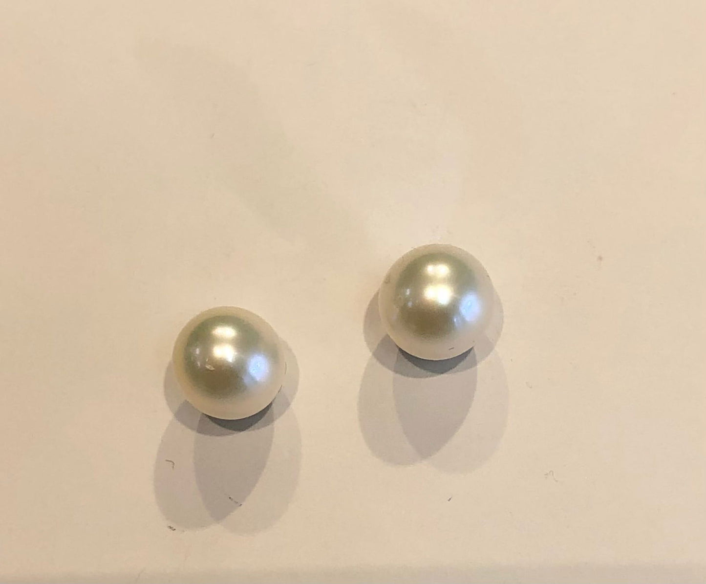 Photo of Freshwater Pearl Stud earrings 5-6mm in a decorative scene, designed by , available at Plumb Gold & Plumb Silver