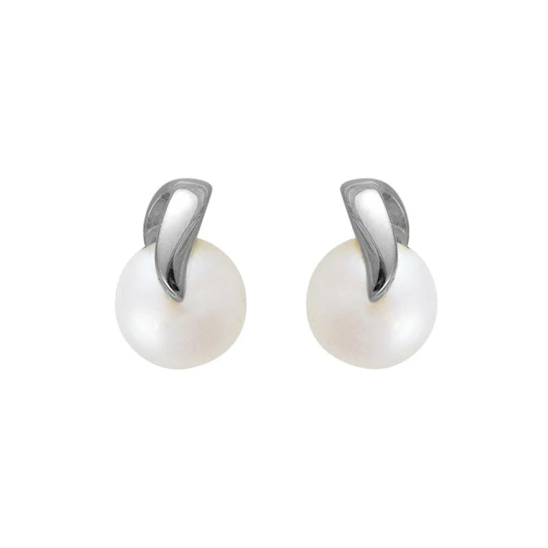 Photo of Freshwater Pearl Swirl Stud in a decorative scene, designed by , available at Plumb Gold & Plumb Silver