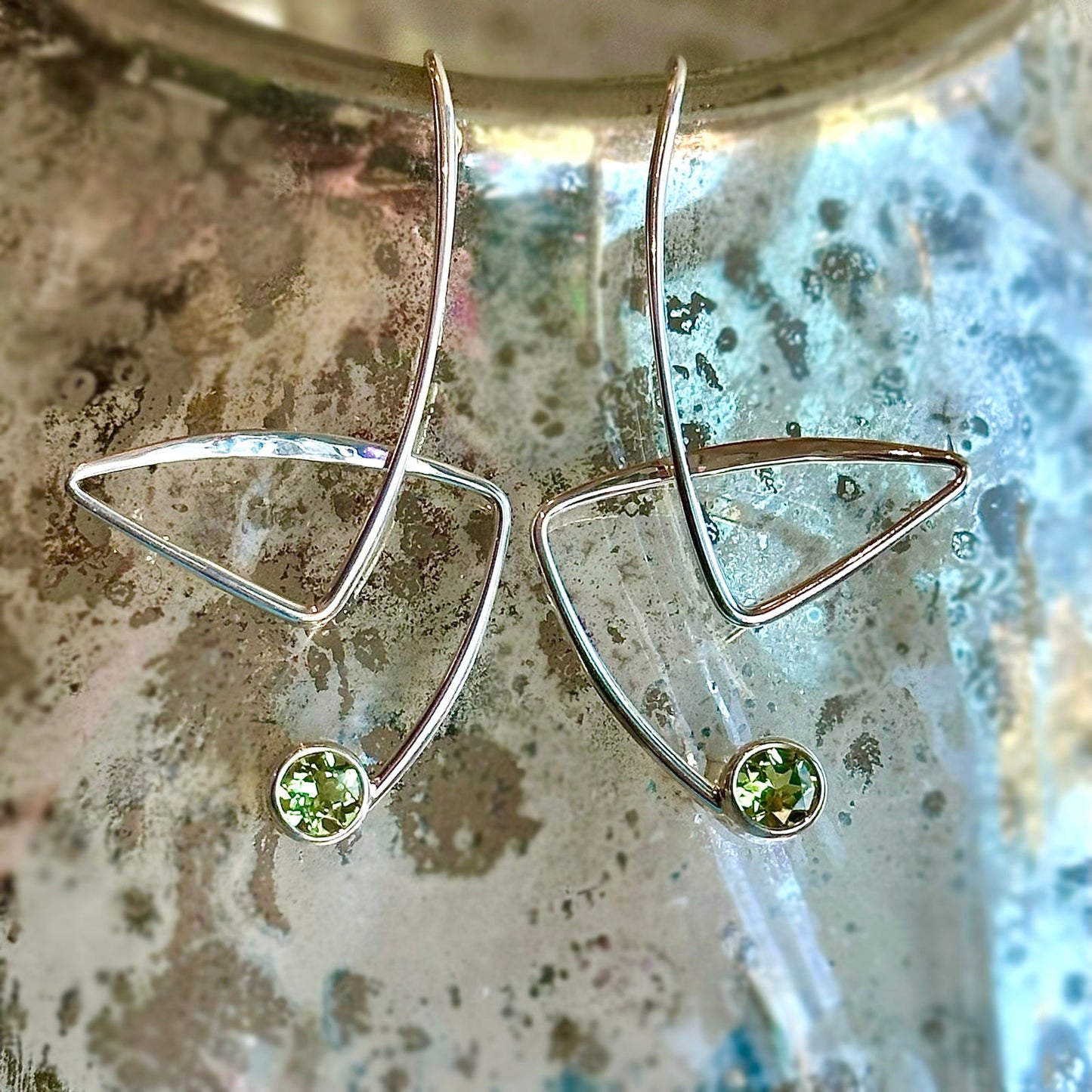 Photo of "Gadabout" Earrings in a decorative scene, designed by , available at Plumb Gold & Plumb Silver