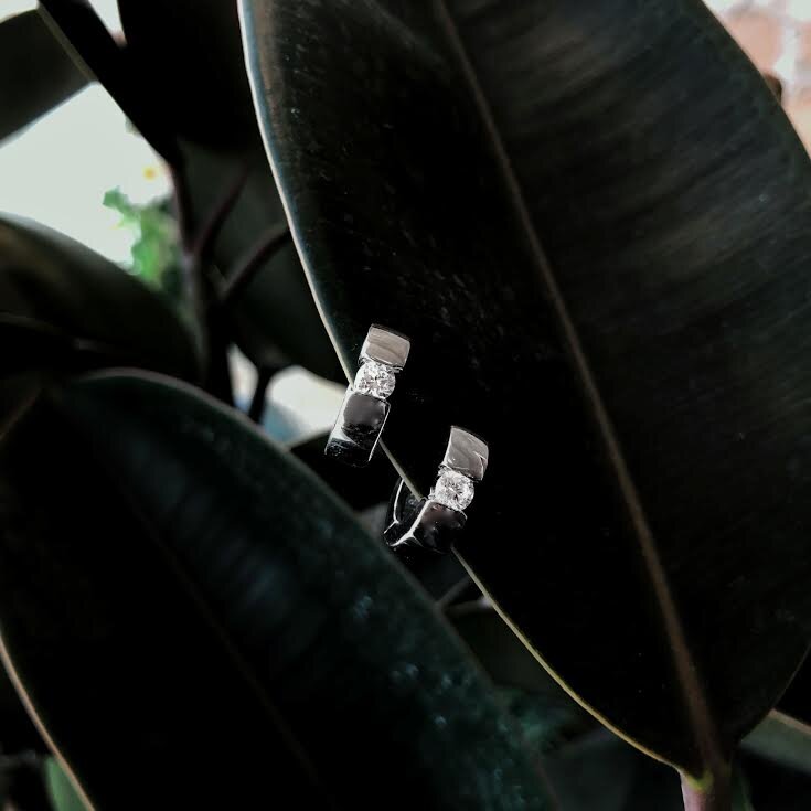 Photo of Gemstone Huggie Earrings in a decorative scene, designed by , available at Plumb Gold & Plumb Silver