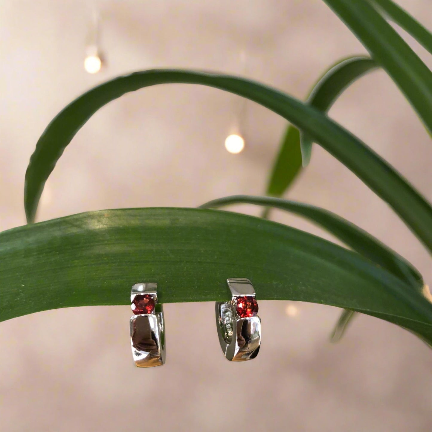 Photo of Gemstone Huggie Earrings in a decorative scene, designed by , available at Plumb Gold & Plumb Silver