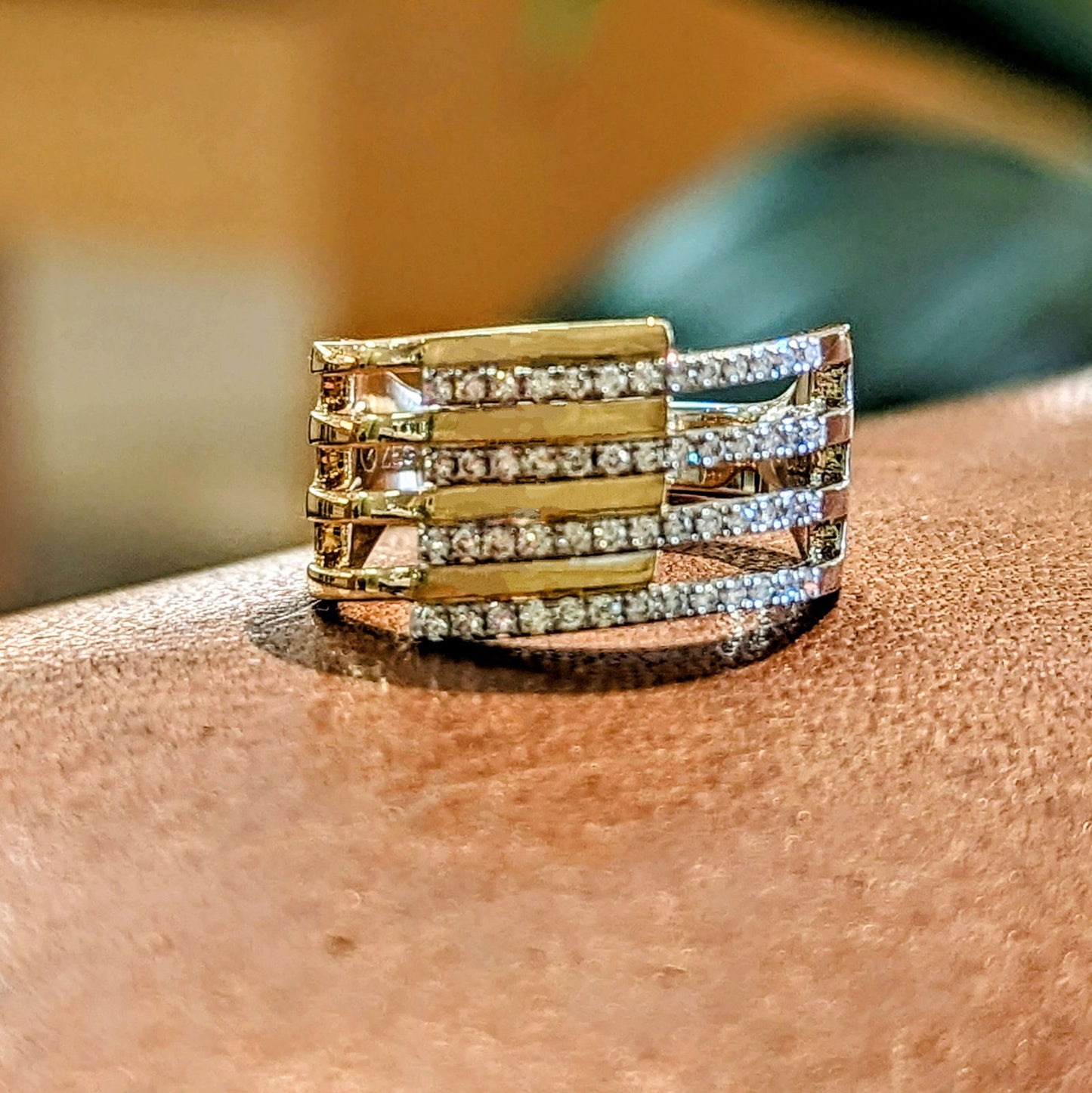 Photo of "Geo" Wrap Diamond Ring in a decorative scene, designed by , available at Plumb Gold & Plumb Silver