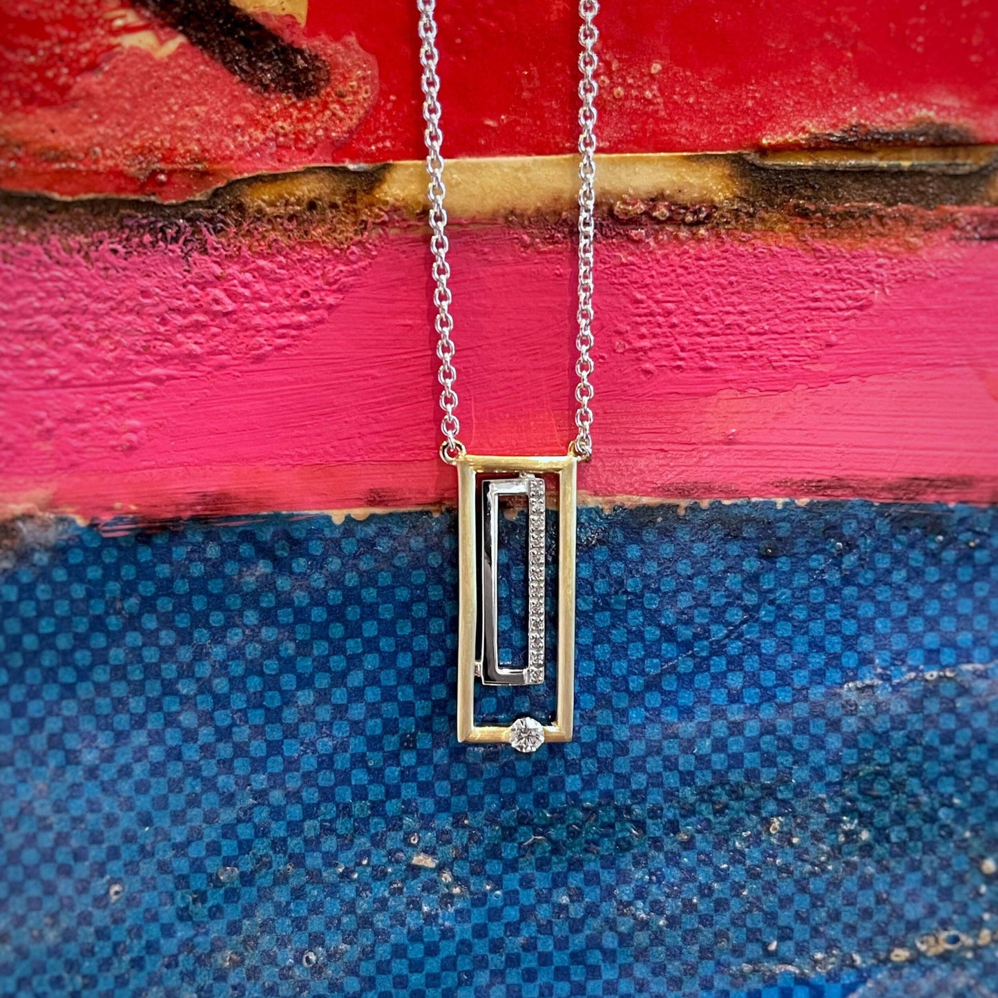 Photo of Geometric Diamond Necklace in a decorative scene, designed by , available at Plumb Gold & Plumb Silver