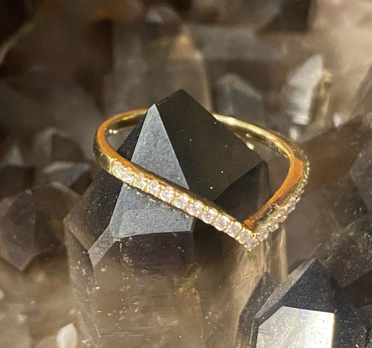Photo of "Gigi" Chevron Diamond Band in a decorative scene, designed by , available at Plumb Gold & Plumb Silver