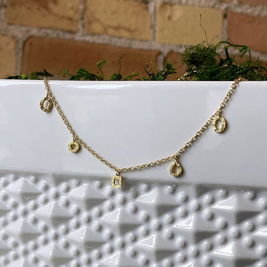 Photo of “Gold Drops” Necklace in a decorative scene, designed by , available at Plumb Gold & Plumb Silver