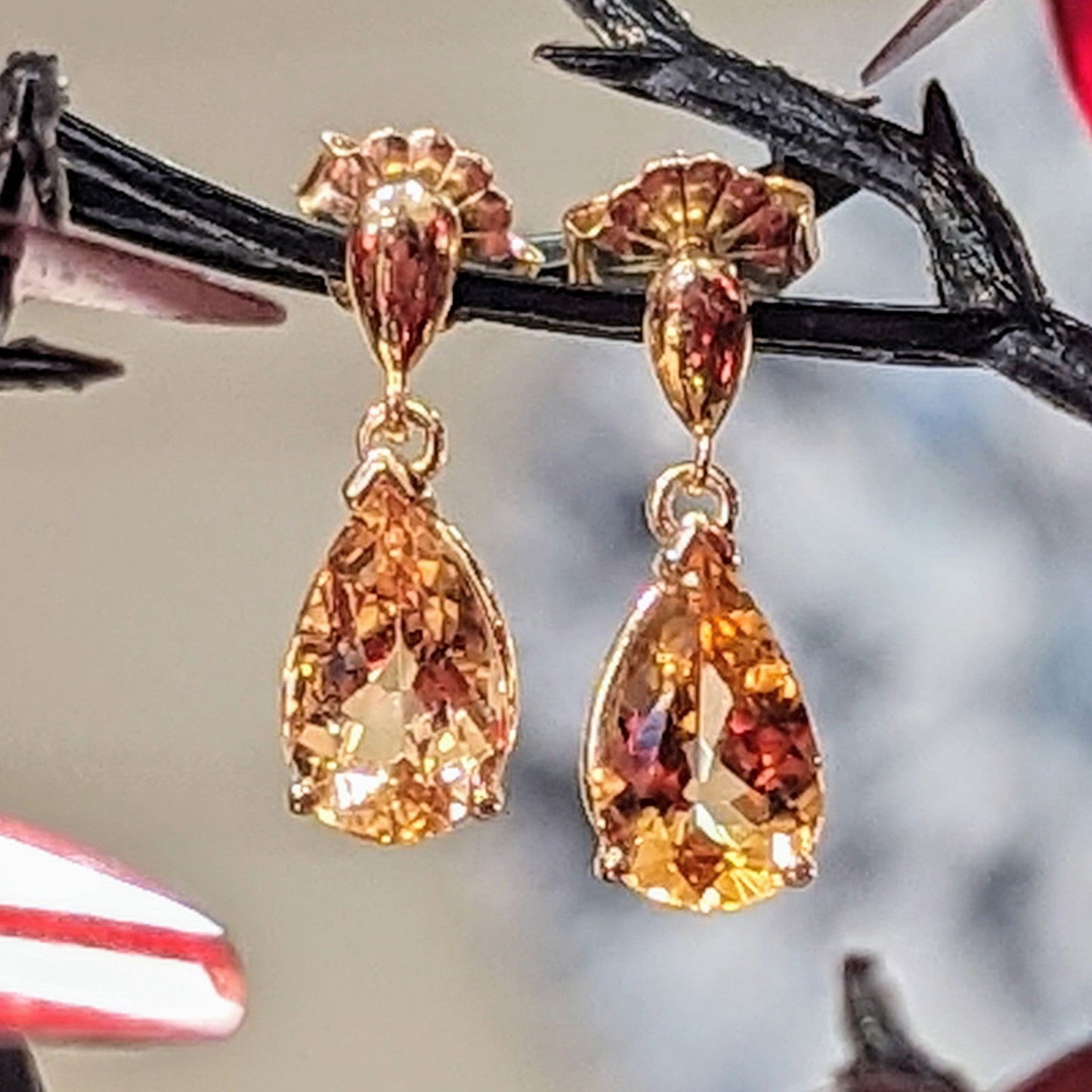 Photo of Golden Topaz Dangle Earrings in a decorative scene, designed by , available at Plumb Gold & Plumb Silver