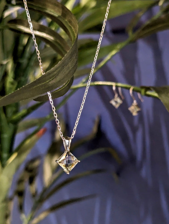 Photo of Green Quartz Necklace in a decorative scene, designed by , available at Plumb Gold & Plumb Silver
