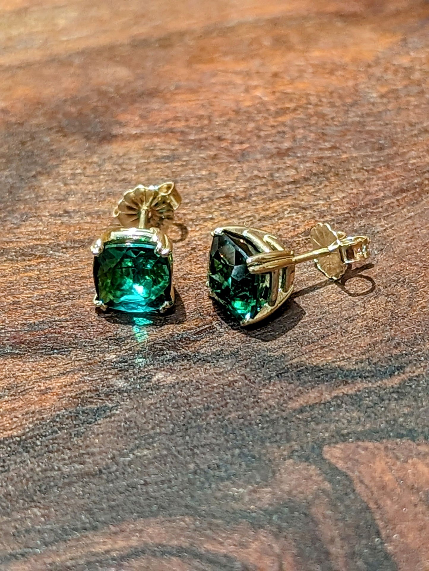 Photo of Green Tourmaline Earrings in a decorative scene, designed by , available at Plumb Gold & Plumb Silver