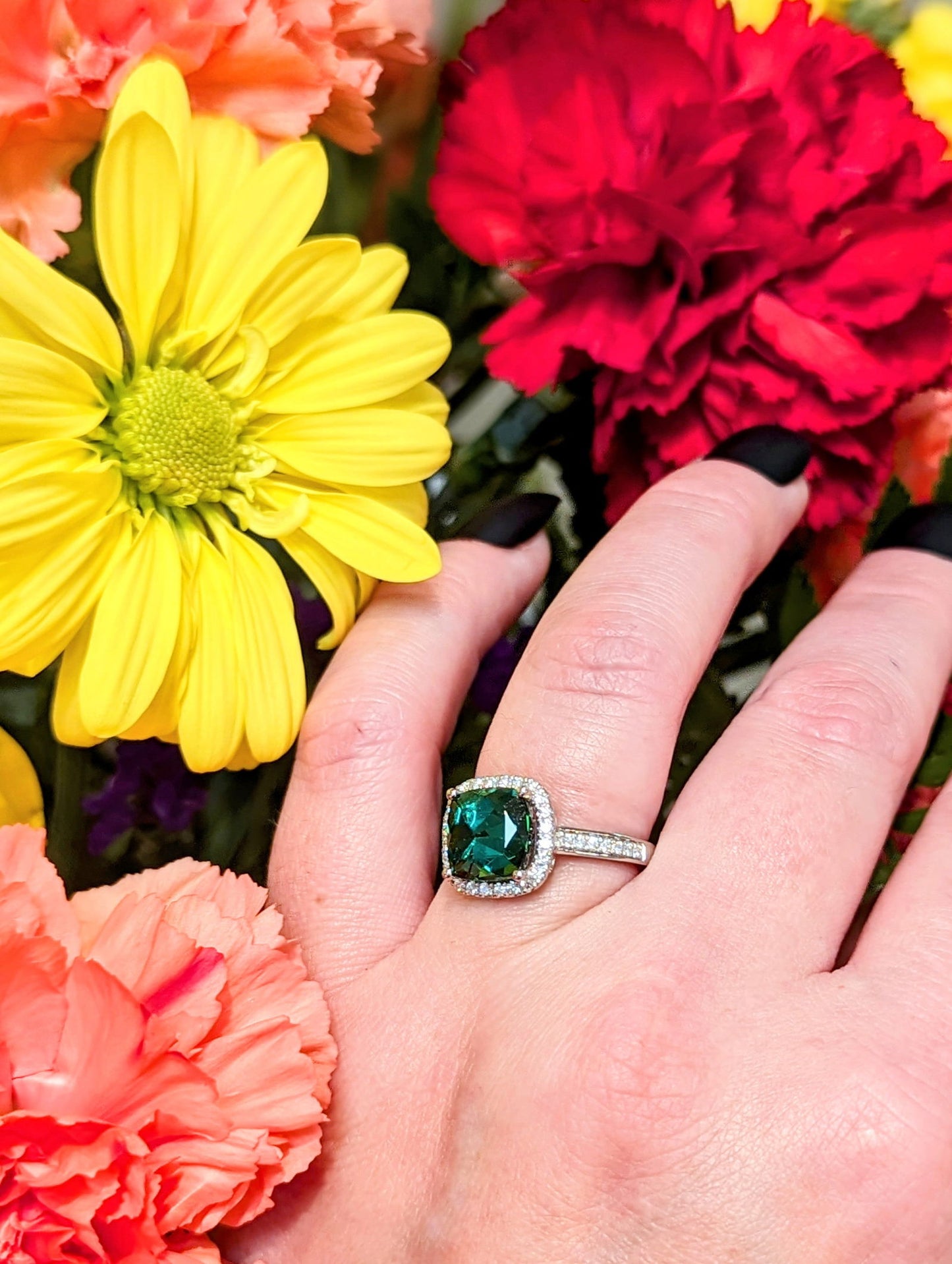 Photo of Green Tourmaline Halo Ring in a decorative scene, designed by , available at Plumb Gold & Plumb Silver