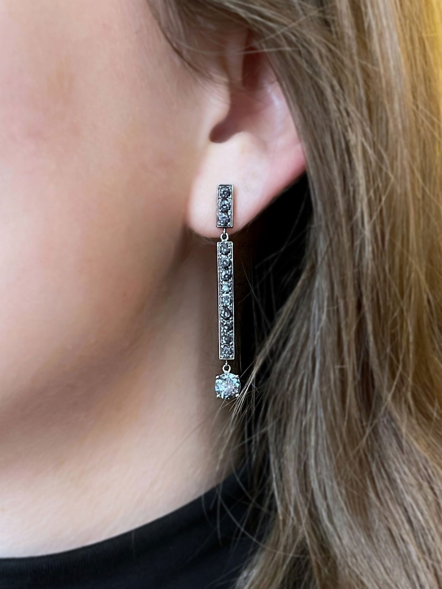 Photo of Grey Spinel Bar Dangles in a decorative scene, designed by , available at Plumb Gold & Plumb Silver