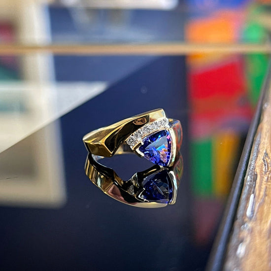 Photo of HL Tanzanite and Diamond Ring in a decorative scene, designed by , available at Plumb Gold & Plumb Silver