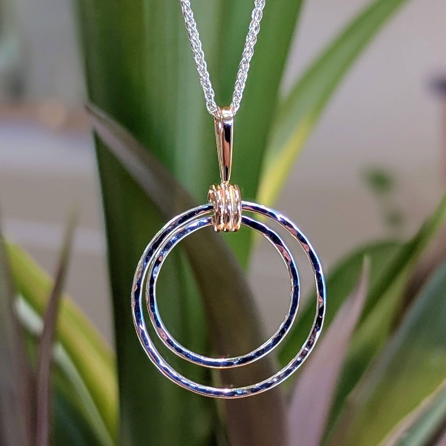 Photo of "Harmony" Pendant in a decorative scene, designed by , available at Plumb Gold & Plumb Silver