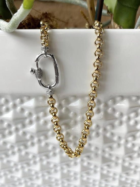 Photo of Heavyweight Fancy Rolo Link in a decorative scene, designed by , available at Plumb Gold & Plumb Silver