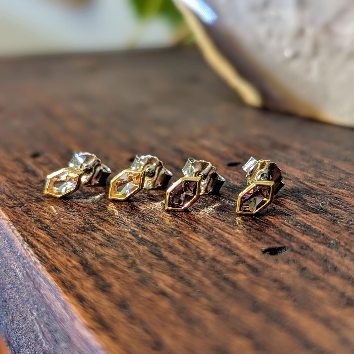 Photo of Hex CZ Studs in a decorative scene, designed by , available at Plumb Gold & Plumb Silver