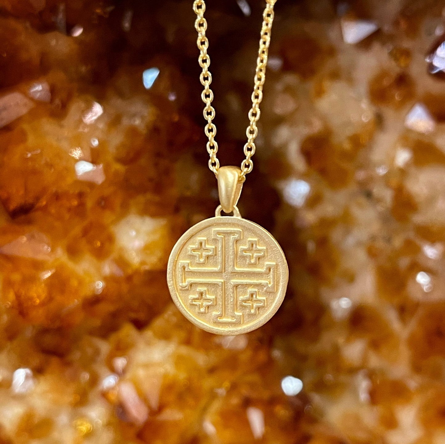 Photo of I. Reiss "Jerusalem" Cross Necklace in a decorative scene, designed by , available at Plumb Gold & Plumb Silver