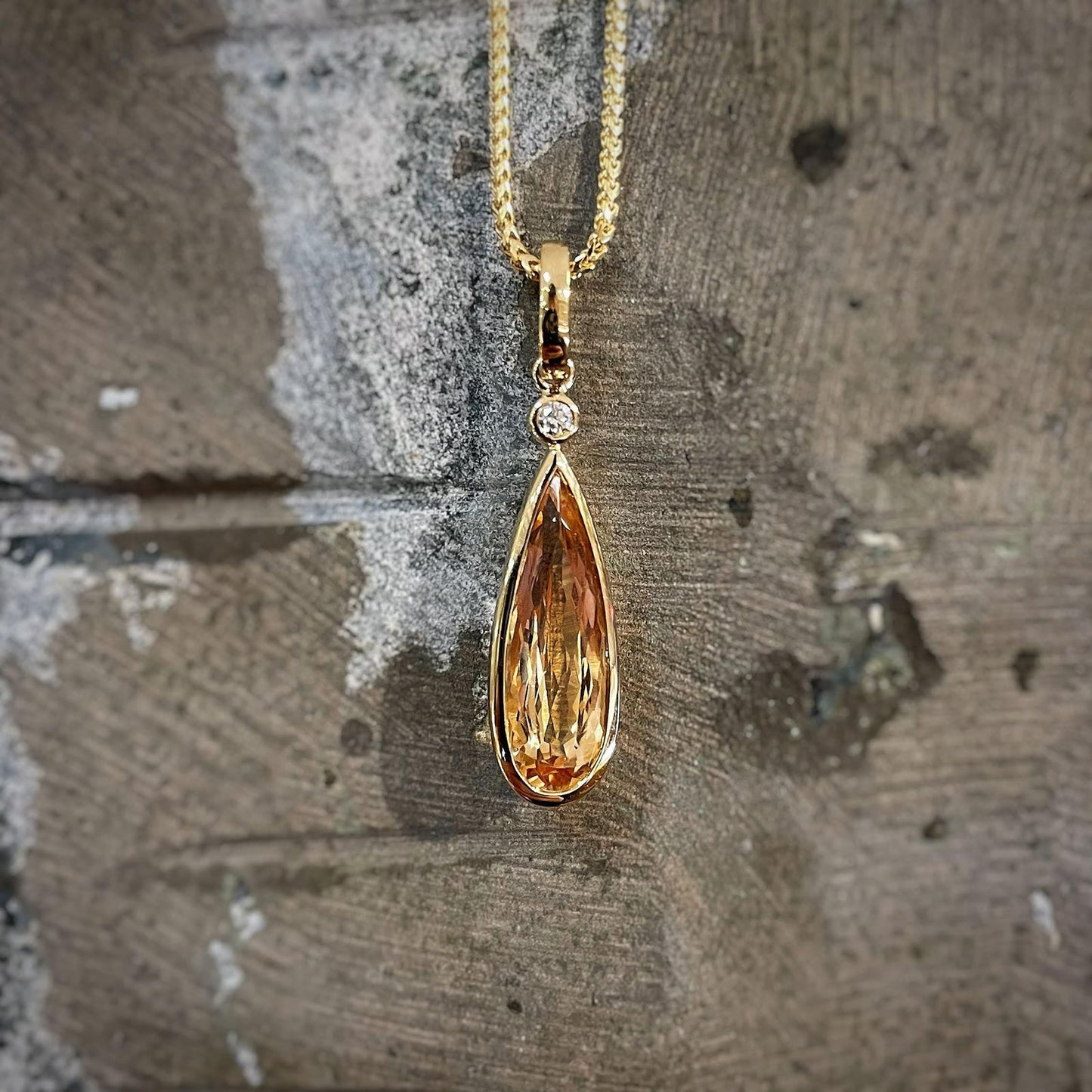 Photo of Imperial Topaz Pendant in a decorative scene, designed by , available at Plumb Gold & Plumb Silver