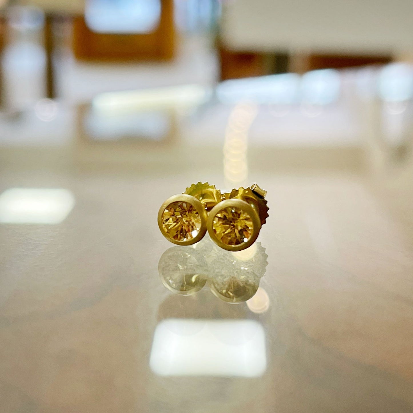 Photo of Imperial Topaz Studs in a decorative scene, designed by , available at Plumb Gold & Plumb Silver