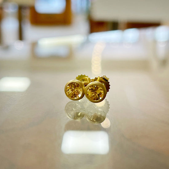 Photo of Imperial Topaz Studs in a decorative scene, designed by , available at Plumb Gold & Plumb Silver