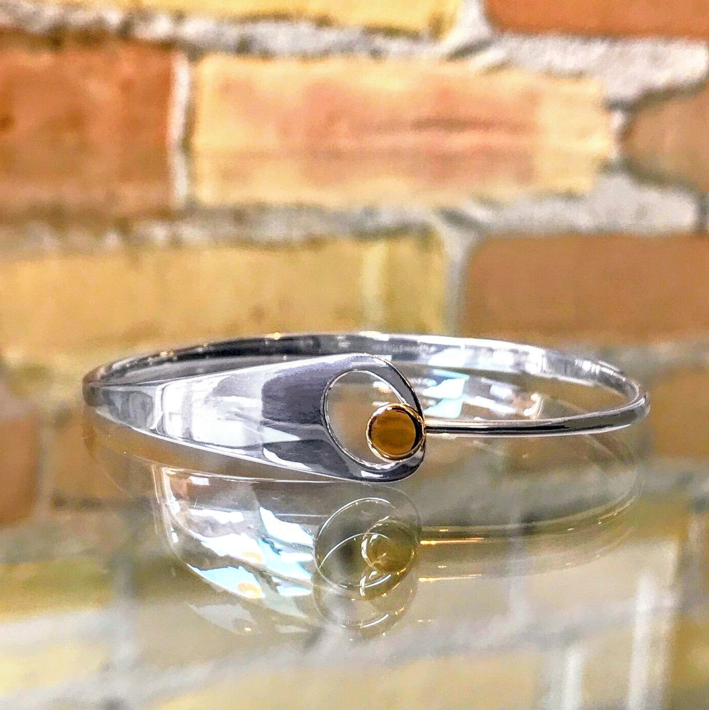 Photo of "Jitterbug" Bracelet in a decorative scene, designed by , available at Plumb Gold & Plumb Silver