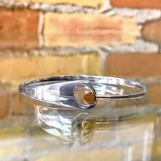 Photo of "Jitterbug" Bracelet in a decorative scene, designed by , available at Plumb Gold & Plumb Silver
