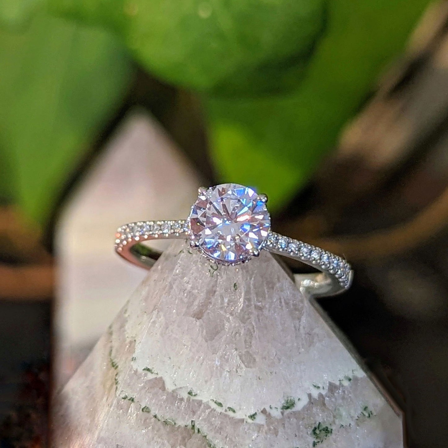 Photo of "Katalina" Hidden Halo Engagement Ring in a decorative scene, designed by , available at Plumb Gold & Plumb Silver
