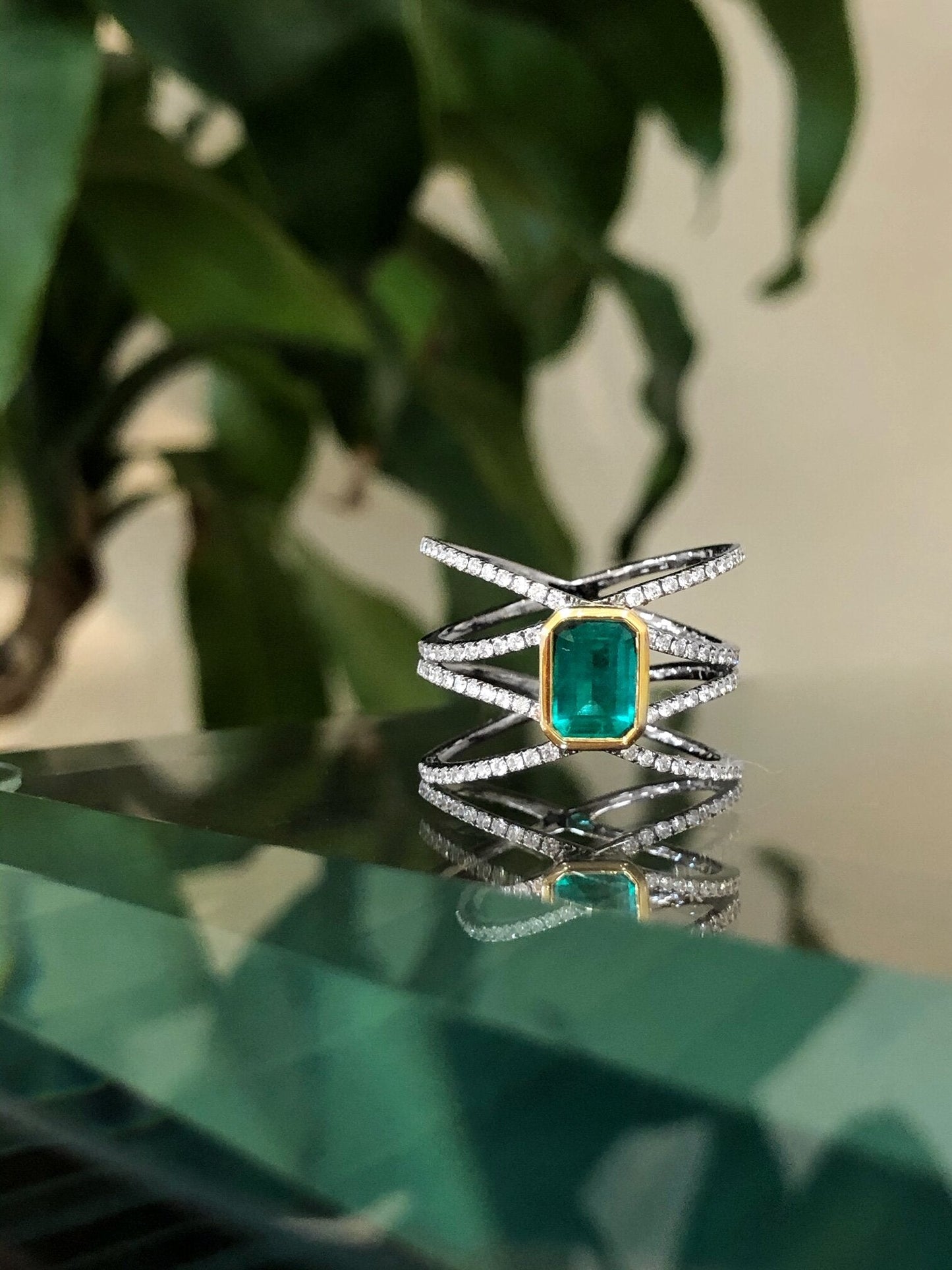 Photo of Kim Collins Emerald and Diamond Statement Ring in a decorative scene, designed by , available at Plumb Gold & Plumb Silver