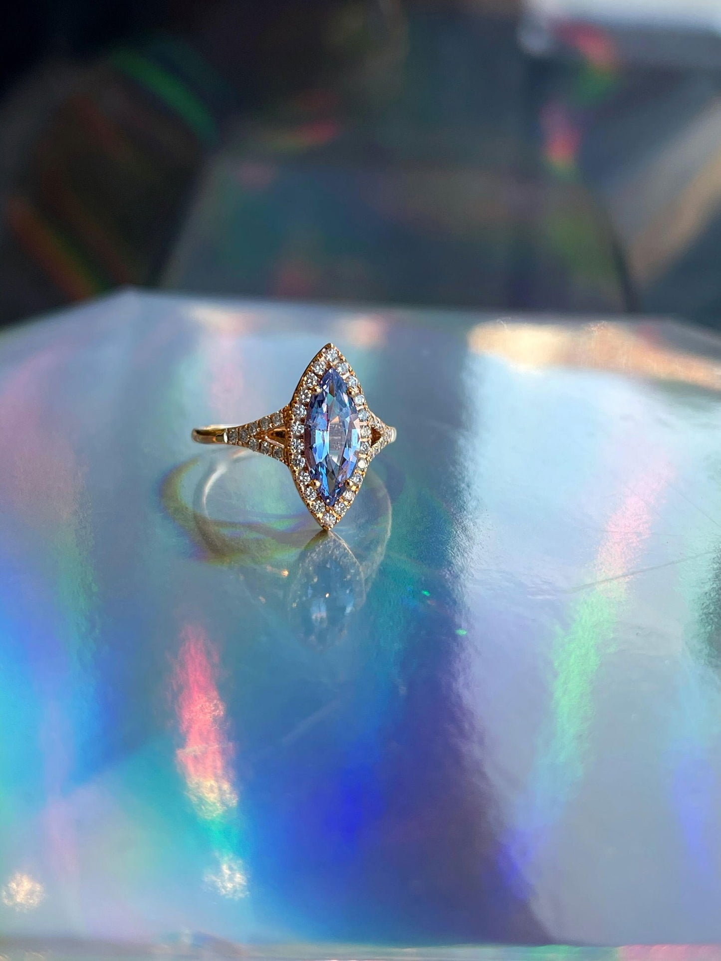 Photo of Kim Collins Lavender Spinel and Diamond Ring in a decorative scene, designed by , available at Plumb Gold & Plumb Silver