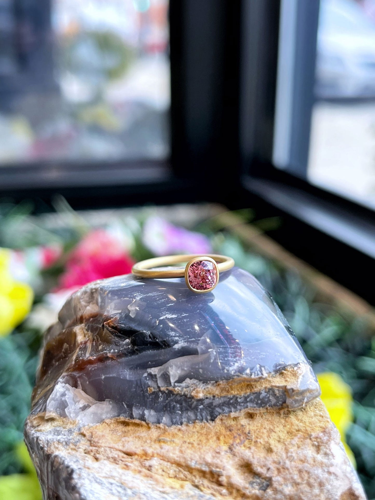 Photo of Kim Collins Malaya Garnet Yumdrop in a decorative scene, designed by , available at Plumb Gold & Plumb Silver