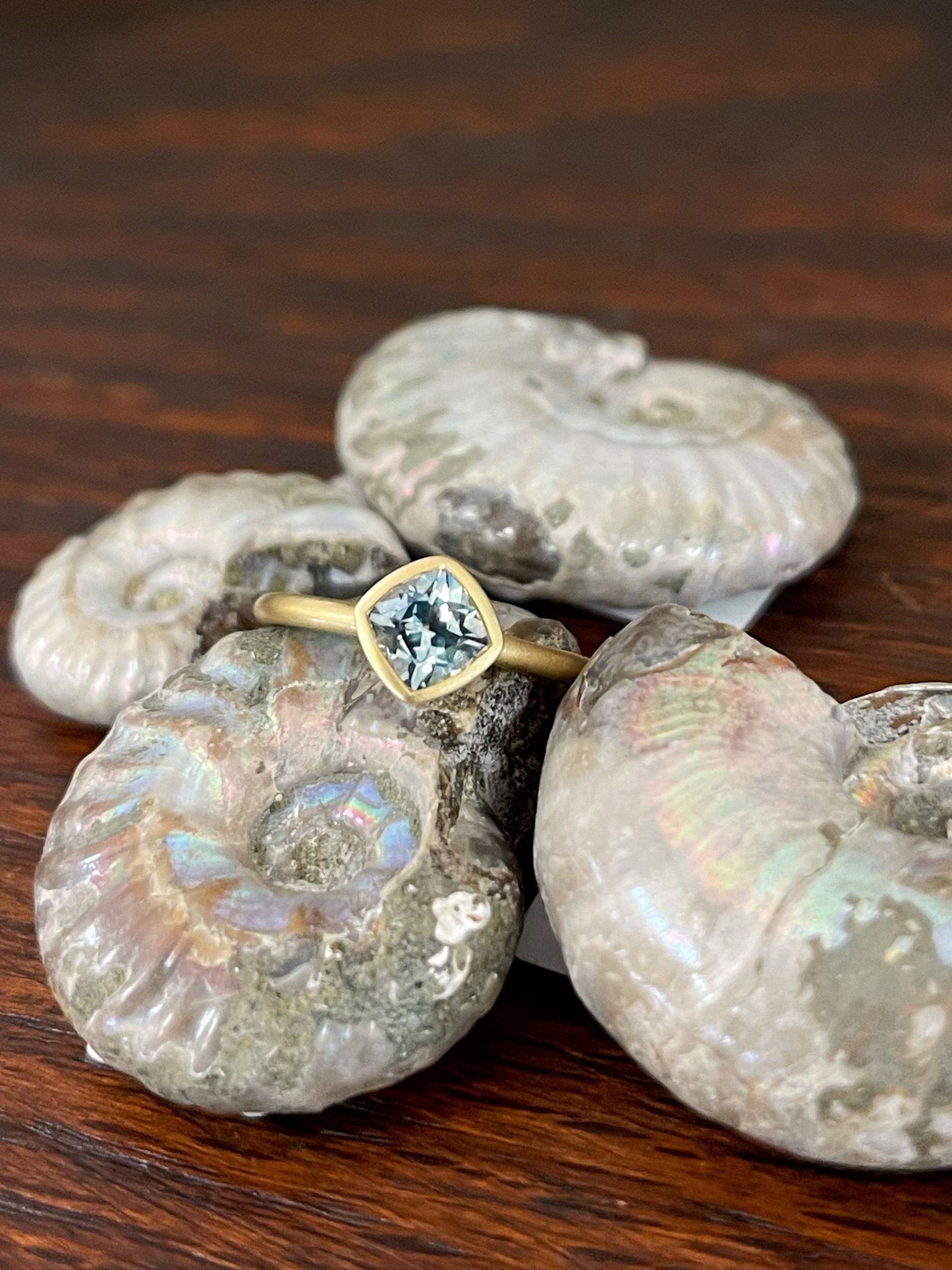 Photo of Kim Collins Montana Sapphire Yumdrop in a decorative scene, designed by , available at Plumb Gold & Plumb Silver
