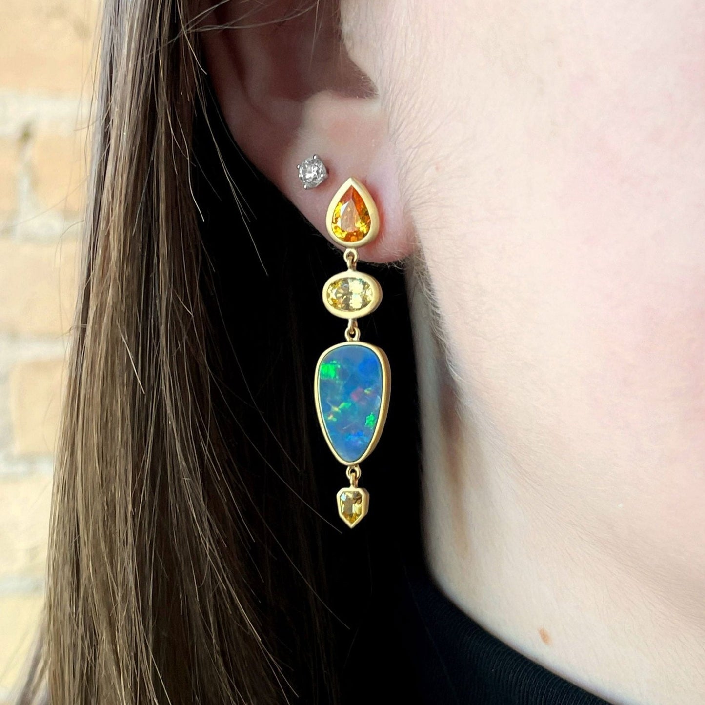 Photo of Kim Collins Multi-Gem Dangles in a decorative scene, designed by , available at Plumb Gold & Plumb Silver