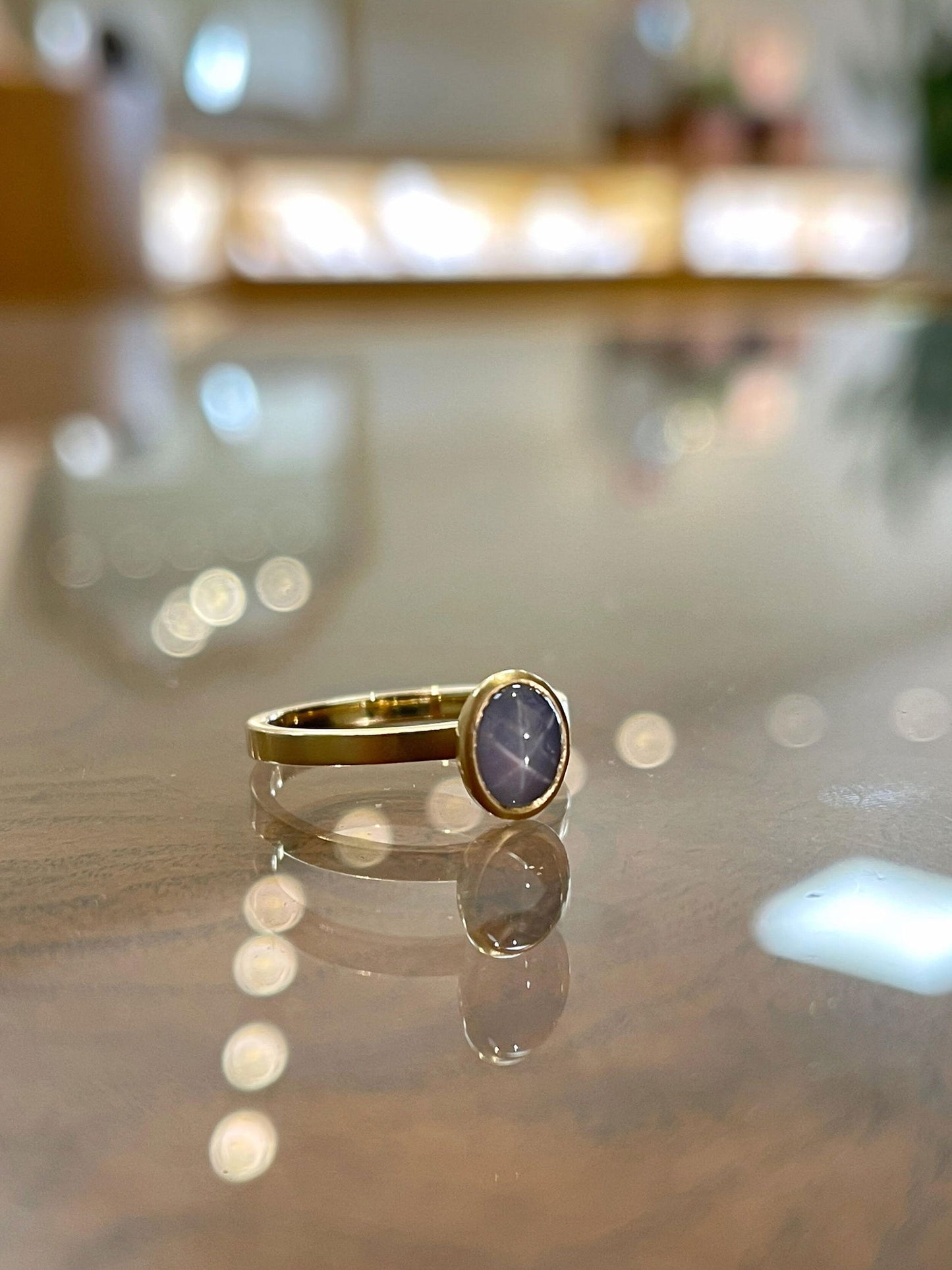 Photo of Kim Collins Star Sapphire Yum Drop in a decorative scene, designed by , available at Plumb Gold & Plumb Silver