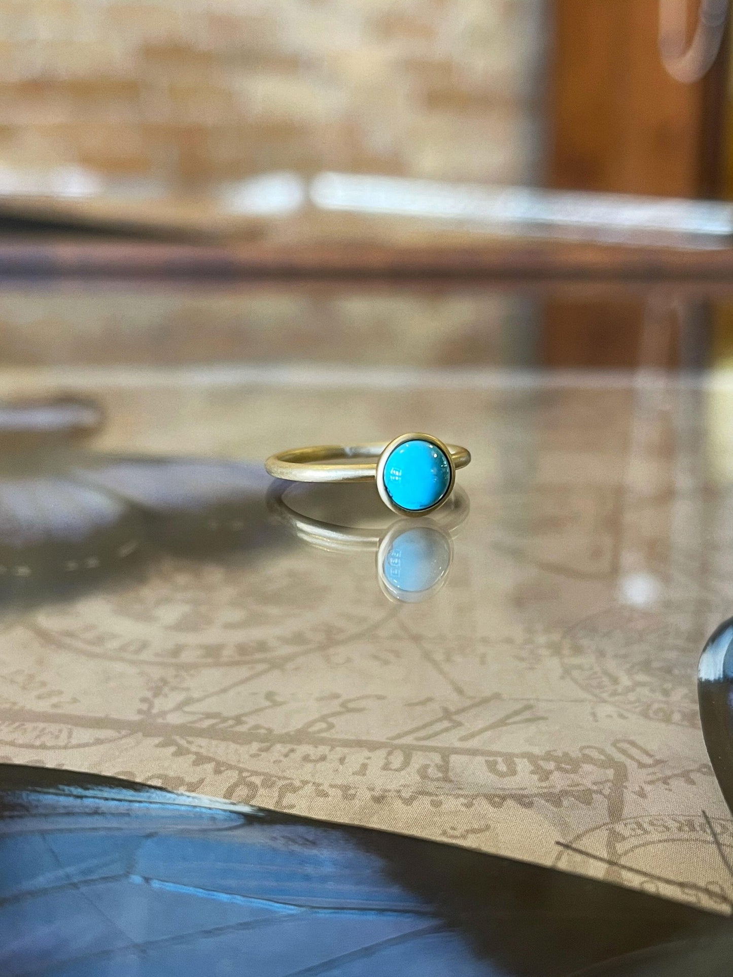Photo of Kim Collins Turquoise Yum Drop in a decorative scene, designed by , available at Plumb Gold & Plumb Silver