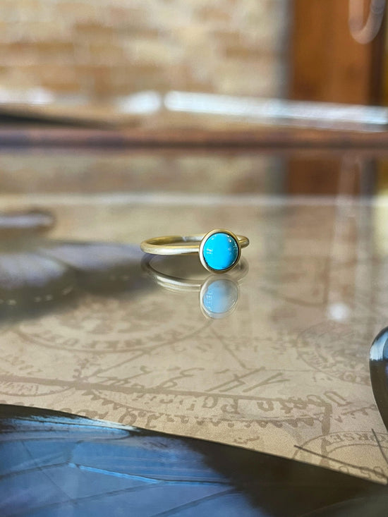 Photo of Kim Collins Turquoise Yum Drop in a decorative scene, designed by , available at Plumb Gold & Plumb Silver