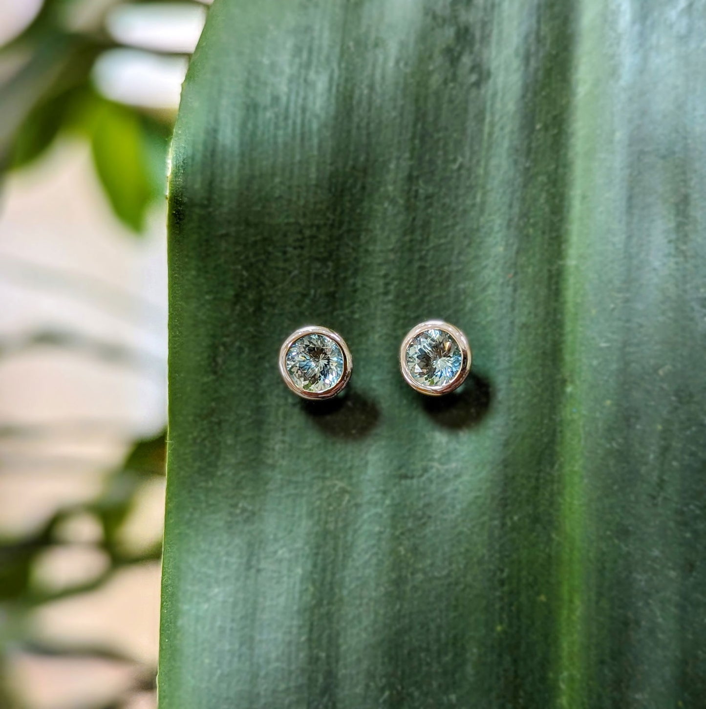 Photo of Kimberly Collins Aquamarine Studs in a decorative scene, designed by , available at Plumb Gold & Plumb Silver
