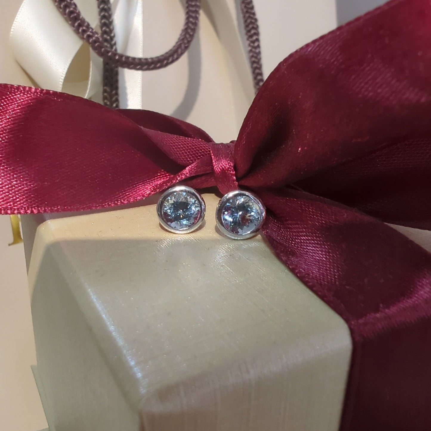 Photo of Kimberly Collins Aquamarine Studs in a decorative scene, designed by , available at Plumb Gold & Plumb Silver