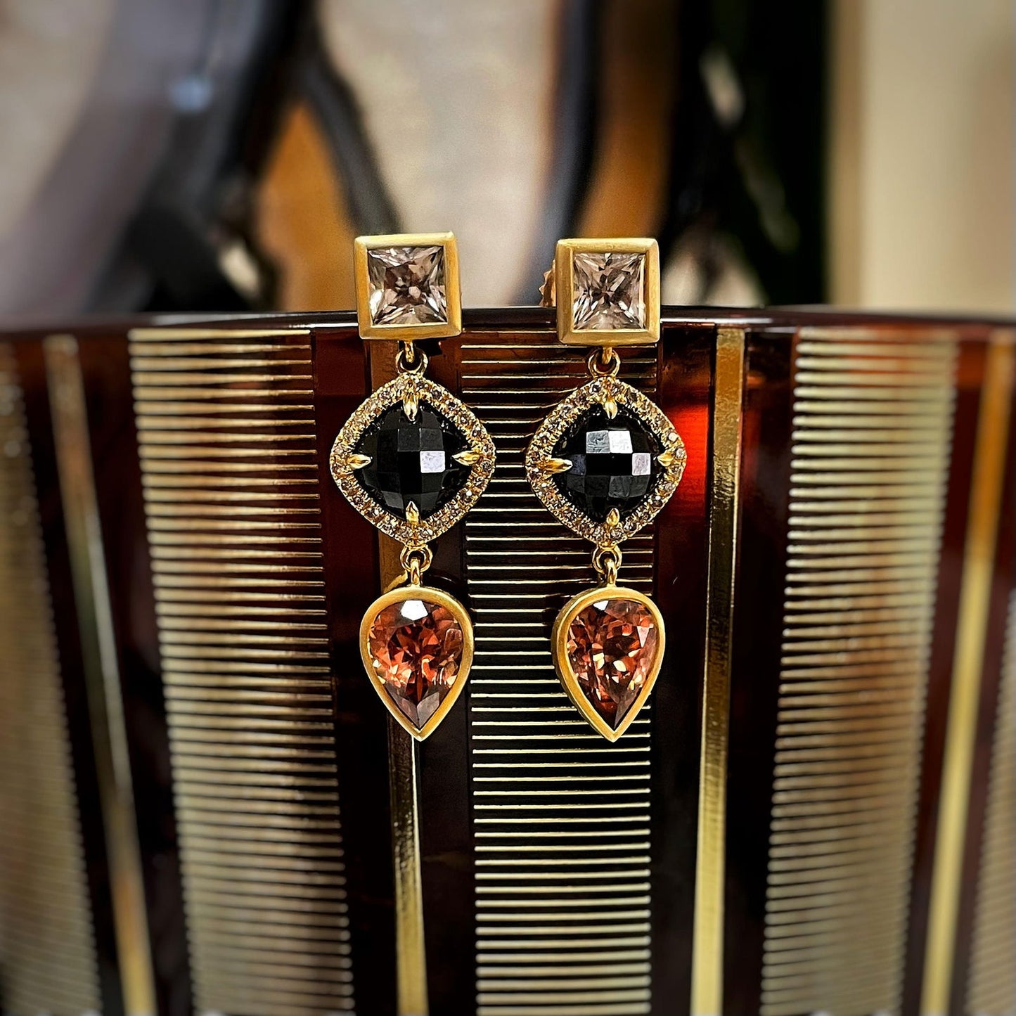 Photo of Kimberly Collins Black Spinel and Zircon Dangles in a decorative scene, designed by , available at Plumb Gold & Plumb Silver
