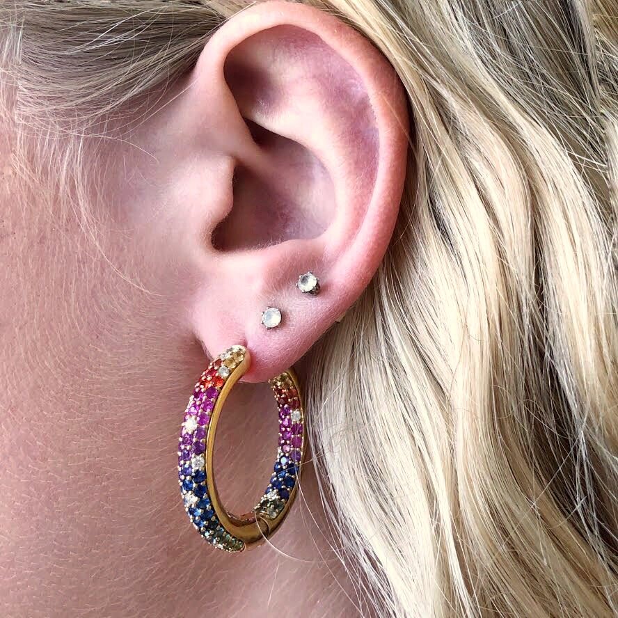 Photo of Kimberly Collins Rainbow Sapphire Hoops in a decorative scene, designed by , available at Plumb Gold & Plumb Silver