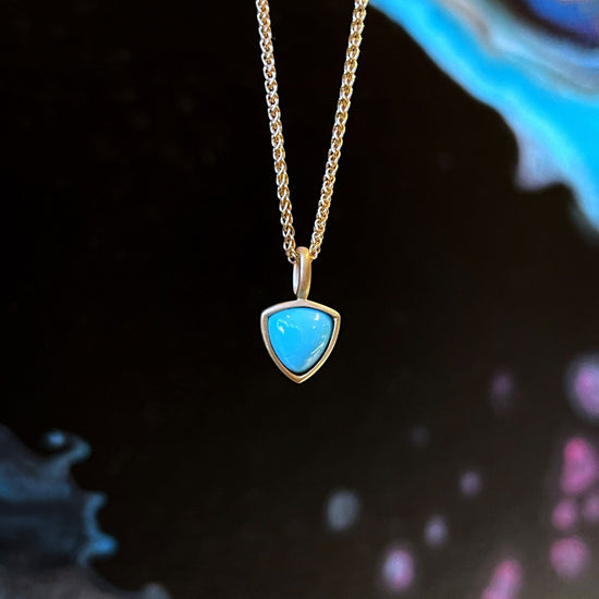 Photo of Kimberly Collins Turquoise Pendant in a decorative scene, designed by , available at Plumb Gold & Plumb Silver
