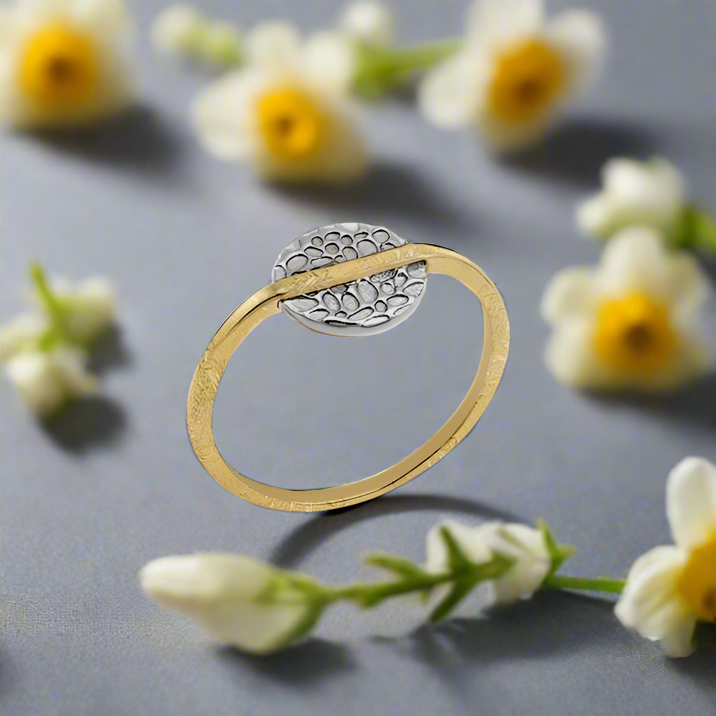 Photo of “Kymbal” Ring in a decorative scene, designed by , available at Plumb Gold & Plumb Silver